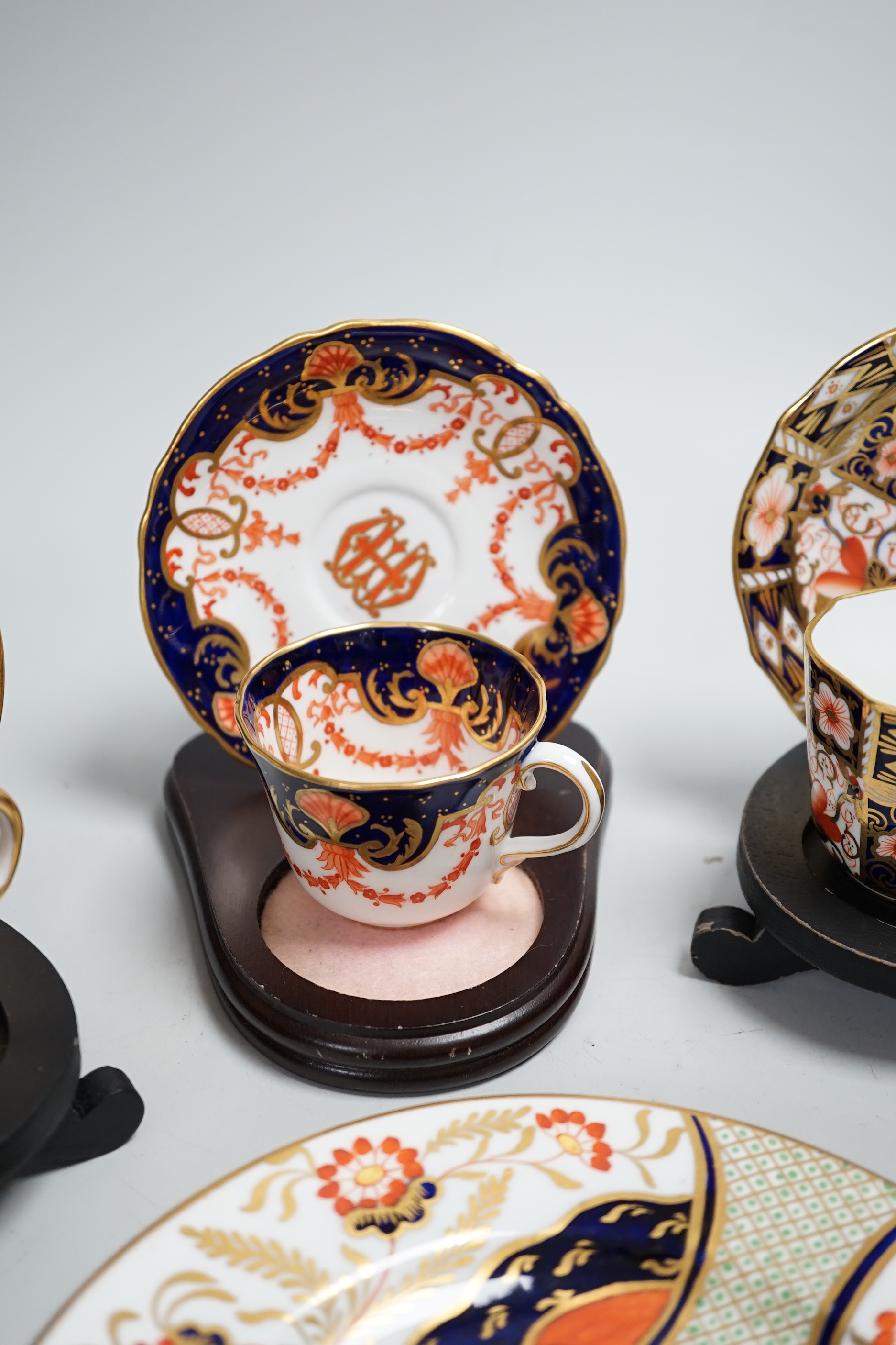 Three pairs of Royal Crown Derby porcelain cups and saucers, another Spode and a Victorian trio